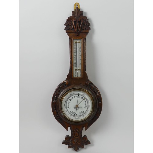 301A - An Edwardian oak aneroid banjo barometer, London maker, 64cm.