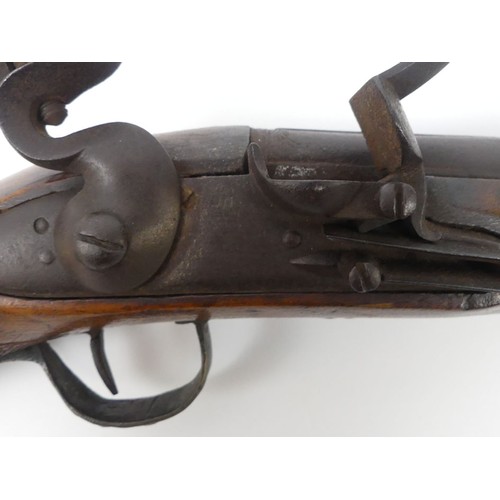 192 - A flintlock mahogany stock blunderbuss with brass fittings, marked 84-86 to the barrel. Length 39 cm... 