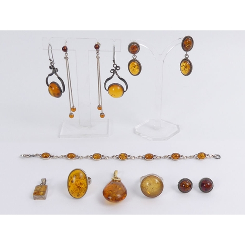 37 - A box of silver and amber jewellery, including rings, pendants and earrings, 43 grams.