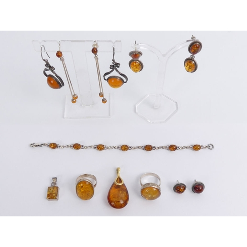 37 - A box of silver and amber jewellery, including rings, pendants and earrings, 43 grams.