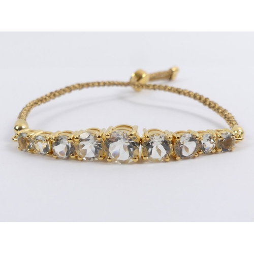 41 - Sterling silver gilt graduated aquamarine set bracelet, 9.8 grams, 8mm, adjustable length.