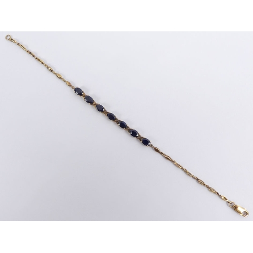 42 - Sterling silver gilt and sapphire set bracelet, 4.8 grams, 19cm.