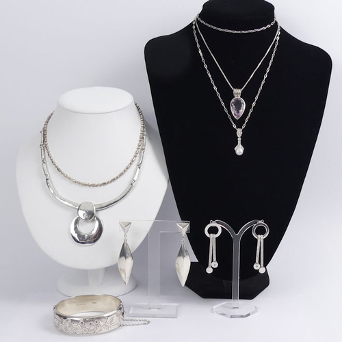 53 - A box of silver jewellery including a hinged bangle and an amethyst pendant and chain, 135 grams.