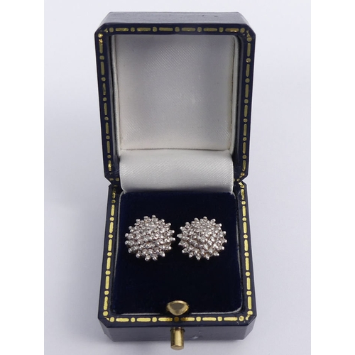 56 - A pair of 9ct gold diamond cluster earrings, 3.5 grams, 12mm.