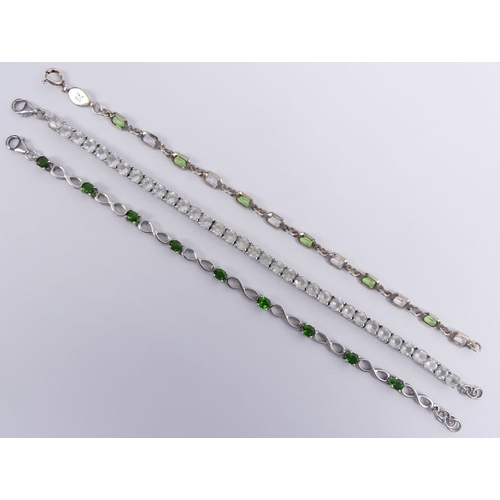 58 - Silver and chrome diopside bracelet, a peridot and topaz silver bracelet and a silver and white ston... 