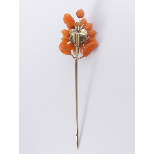 62 - Victorian carved coral and 9ct gold (tested) stick pin, 3.4 grams, 75mm.