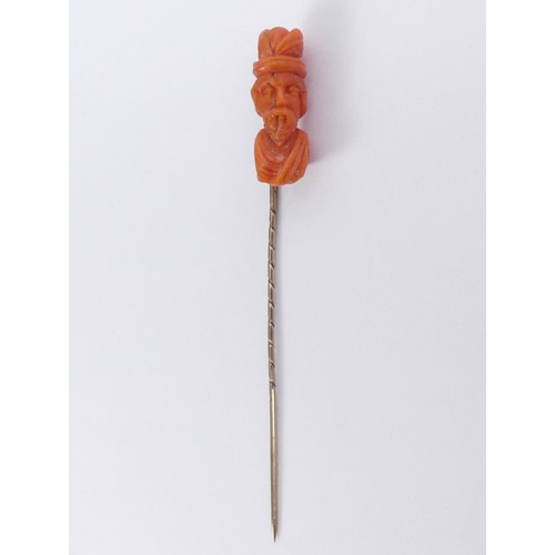 63 - Victorian carved coral and 9ct gold (tested) stick pin, 2.5 grams, 75mm.