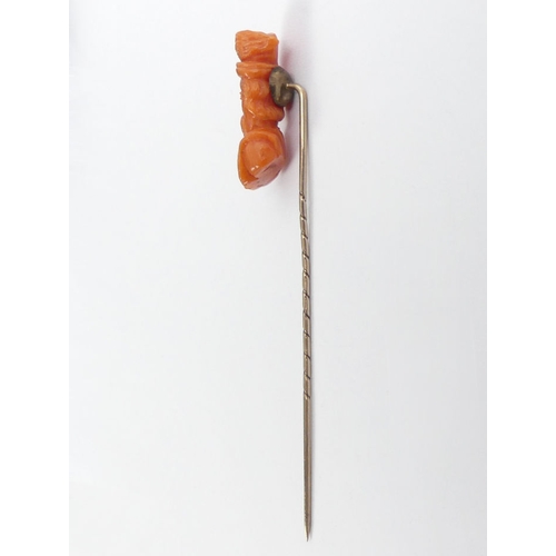 63 - Victorian carved coral and 9ct gold (tested) stick pin, 2.5 grams, 75mm.