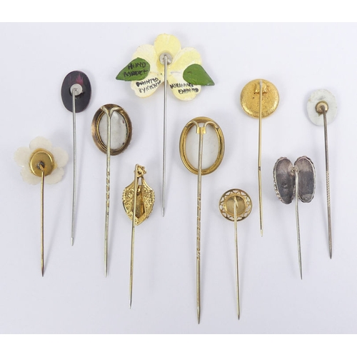 64 - Ten various stick pins, including hand painted examples, 8.5cm.