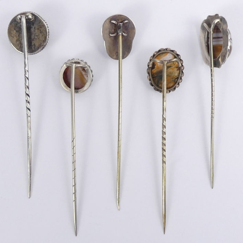 71 - A silver and agate jockey cap stick pin, Birm. 1893, along with four silver and agate examples, jock... 