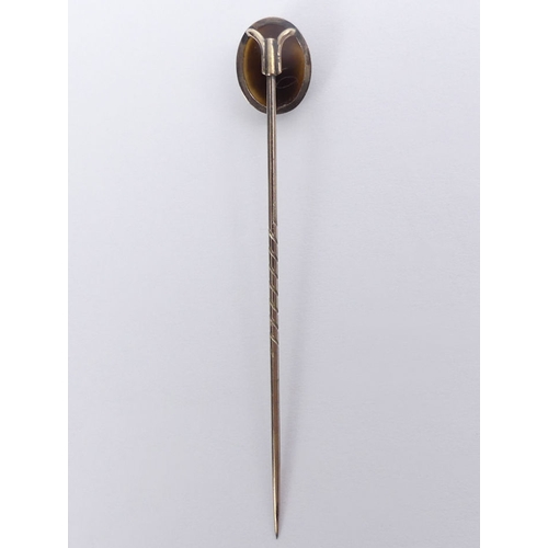 74 - 9ct gold, (tested) finely carved hardstone cameo stick pin, 1.6 grams, 67mm.