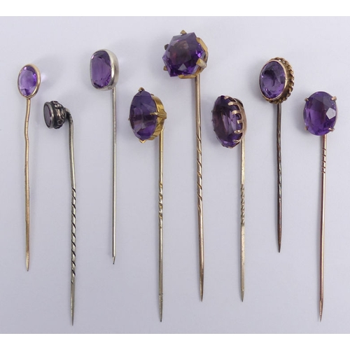 80 - Nine amethyst set stick pins, three test as gold, 76mm.