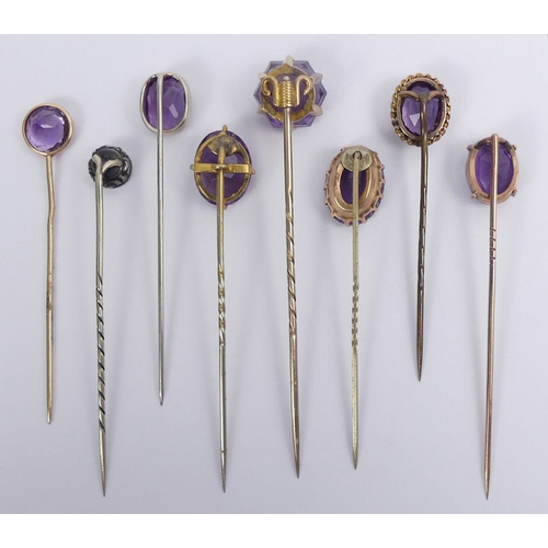 80 - Nine amethyst set stick pins, three test as gold, 76mm.