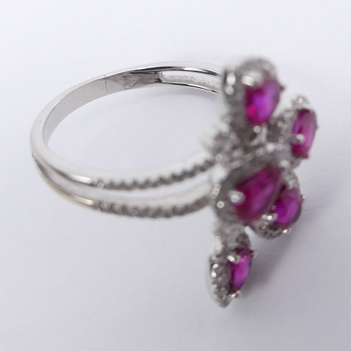 84 - 18ct white gold, ruby and diamond ring, 5.9 grams, 23.5mm. Size R 1/2. 23.5 mm wide.