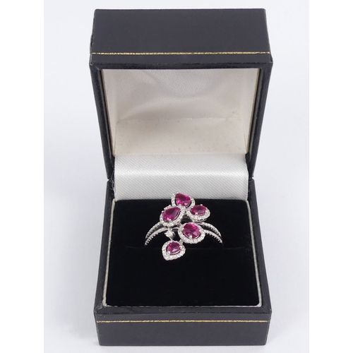 84 - 18ct white gold, ruby and diamond ring, 5.9 grams, 23.5mm. Size R 1/2. 23.5 mm wide.