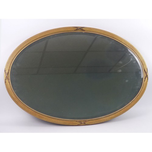 459 - An Edwardian gilt framed oval mirror, 90cm x 61cm. Collection own Courier Only.