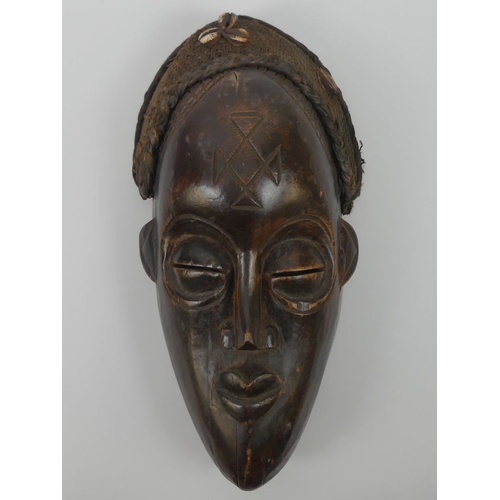 467 - A carved Angola Chokwe tribal mask, 39cm x 17cm.