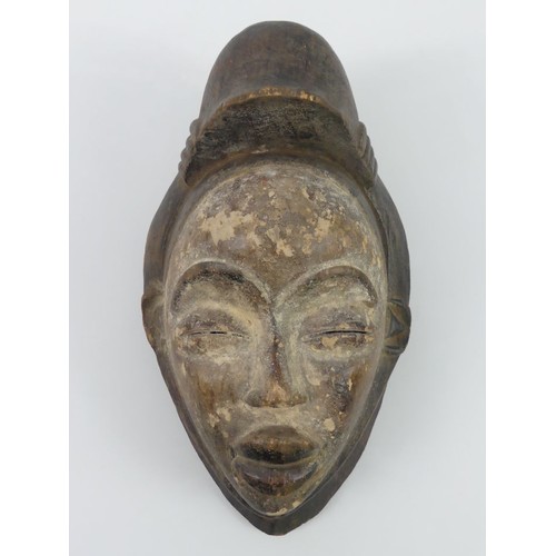 465 - A carved Gabon Punu Maiden Spirit tribal mask, 33cm x 18cm.