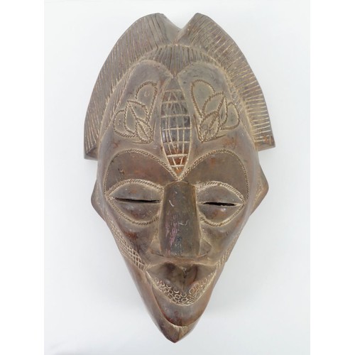 469 - A carved Cameroon Tika tribal mask, 43cm x 28cm.