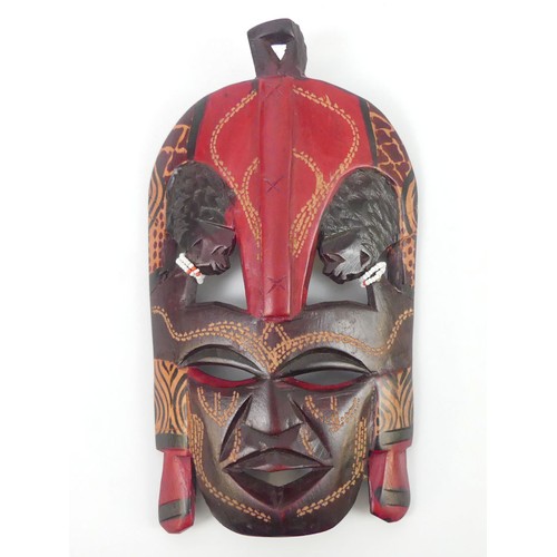 470 - A carved Kenyan Masai tribal mask, 24cm x 14cm.