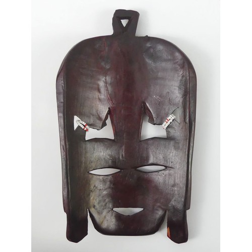 470 - A carved Kenyan Masai tribal mask, 24cm x 14cm.