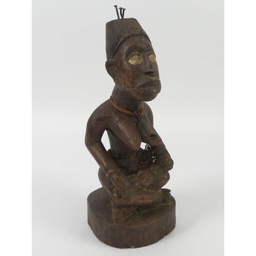 471 - A carved Yoruba female fertility figure, 34cm.