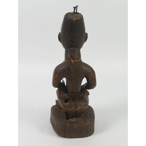 471 - A carved Yoruba female fertility figure, 34cm.