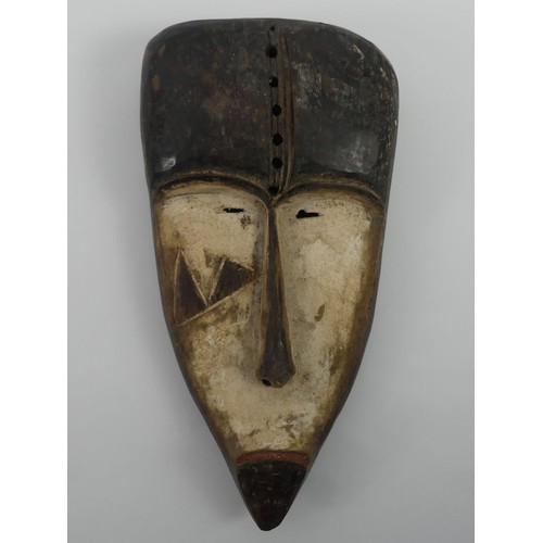 472 - A carved Gabon Fang tribal mask, 39cm x 22cm.