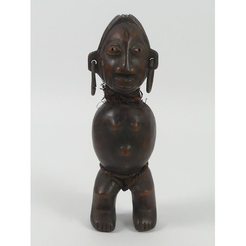 473 - An African carved female fertility figure, 27cm.