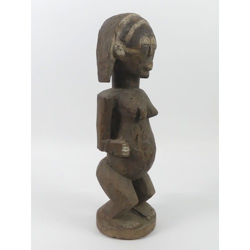 475 - An African carved female fertility figure, 52cm.