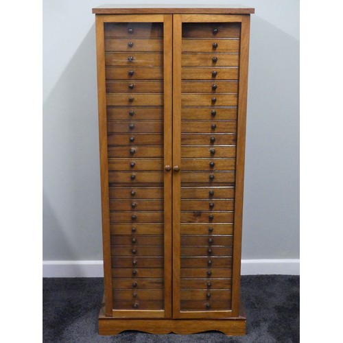 500 - A mid 20th century hardwood collectors cabinet with twenty three drawers and glazed doors, 132cm x 5... 