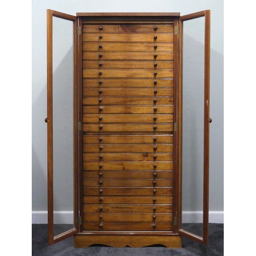 500 - A mid 20th century hardwood collectors cabinet with twenty three drawers and glazed doors, 132cm x 5... 