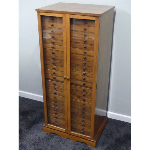 500 - A mid 20th century hardwood collectors cabinet with twenty three drawers and glazed doors, 132cm x 5... 