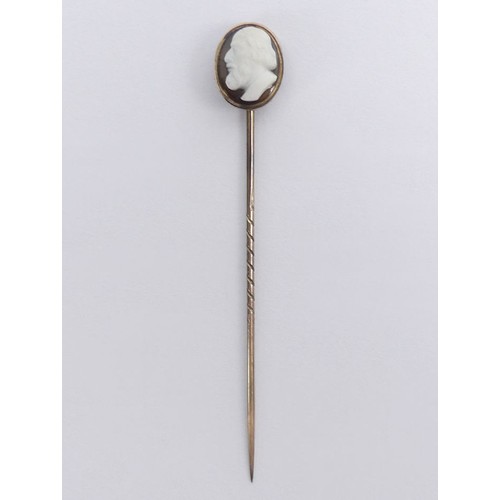 74 - 9ct gold, (tested) finely carved hardstone cameo stick pin, 1.6 grams, 67mm.