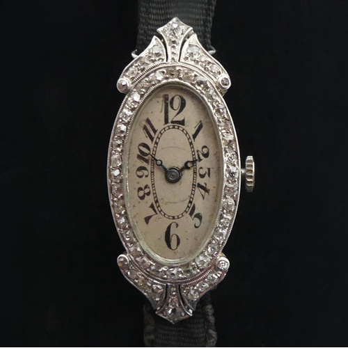 106 - A platinum, Art Deco diamond set cocktail watch, gross weight 12.6 grams, 36.6 mm x 17.3 mm.