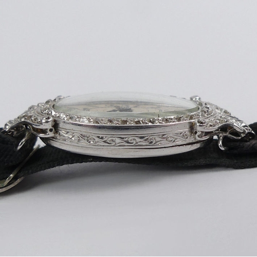 106 - A platinum, Art Deco diamond set cocktail watch, gross weight 12.6 grams, 36.6 mm x 17.3 mm.