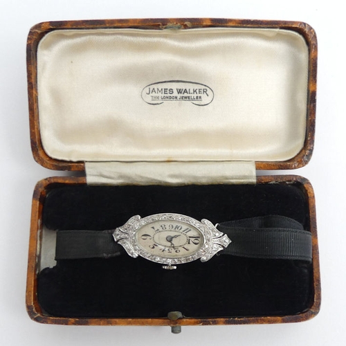 106 - A platinum, Art Deco diamond set cocktail watch, gross weight 12.6 grams, 36.6 mm x 17.3 mm.