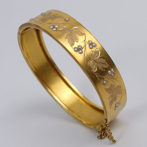 28 - French 18ct gold, seed pearl foliate design hinged bangle, 15 grams, 13.7mm wide.