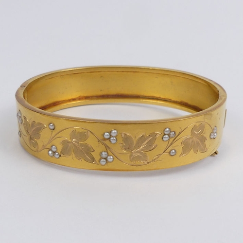 28 - French 18ct gold, seed pearl foliate design hinged bangle, 15 grams, 13.7mm wide.