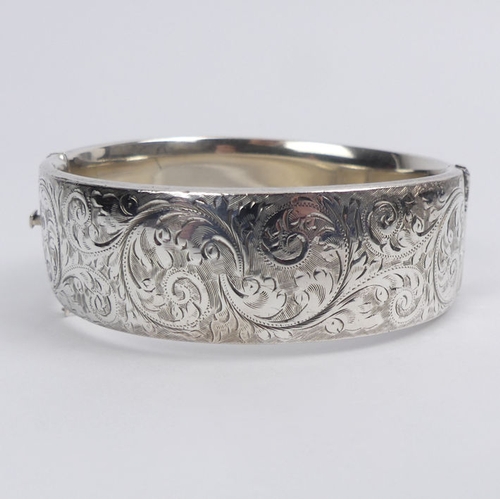 29 - Georg Jensen engraved scrolling feather design hinged silver bangle, London 1959, 63.8 grams, 22mm w... 