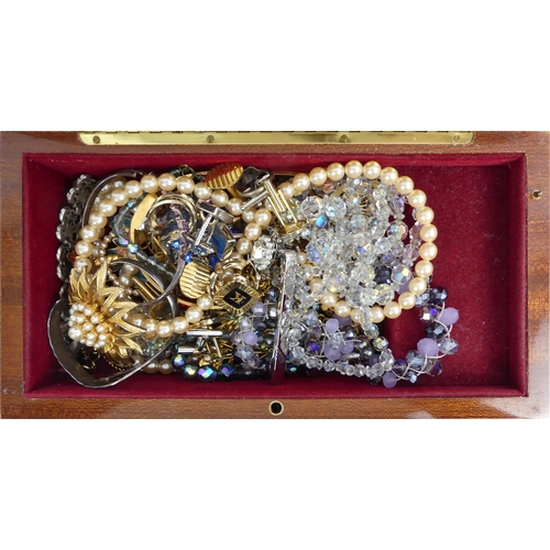 50 - A musical jewellery box of mixed costume jewellery, including two silver bangles.