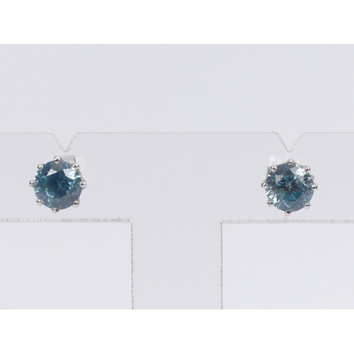 59 - A pair of 9ct white gold, blue topaz stud earrings, 2.2 grams, 7.1mm diameter.