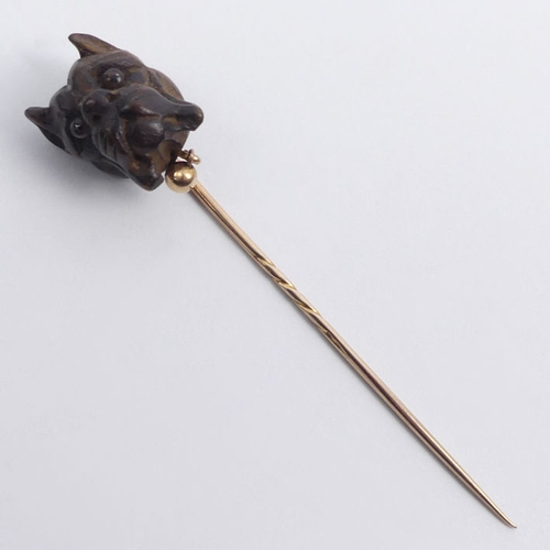 80 - A gold mounted stick pin, carved with a Bulldog,  1.8 grams, 70mm long, top 12.7mm x 17.3mm.