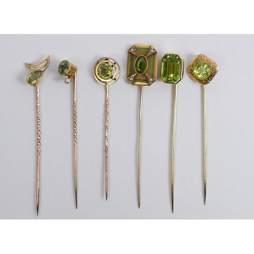 84 - Six Victorian 9ct gold peridot set stick pins, 11.6 grams, longest 67mm.