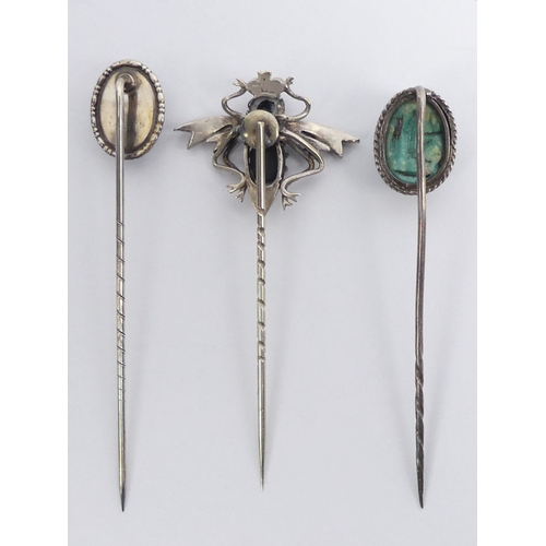 86 - A silver stone set bug design stick pin, along with a butterfly wing example and a scarab beetle exa... 