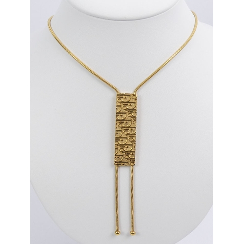 89 - A Christian Dior gold tone pendant necklace, 21.8 grams, pendant 10cm, necklace 42cm.