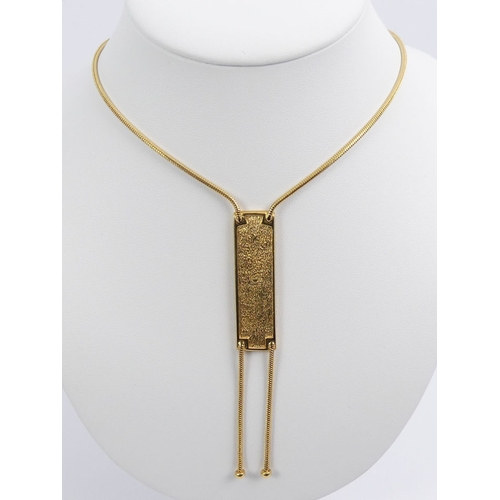 89 - A Christian Dior gold tone pendant necklace, 21.8 grams, pendant 10cm, necklace 42cm.