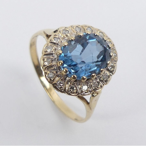 91 - 9ct gold, blue topaz and diamond ring, 2.8 grams, 13.6mm, size M.