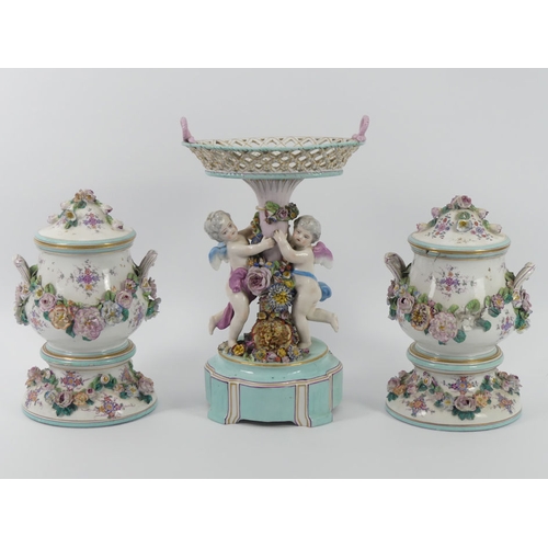 364 - A 19th century German porcelain comport with cherubs and floral decoration, together with a pair of ... 