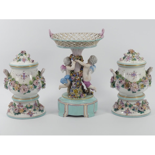 364 - A 19th century German porcelain comport with cherubs and floral decoration, together with a pair of ... 